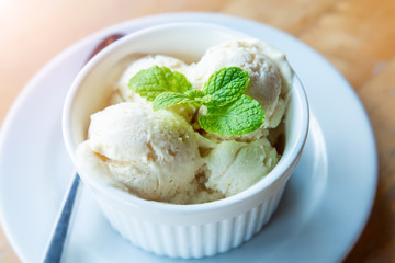 Milk vanila ice creams with mint leaf.