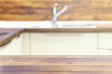 Wood table top on blur kitchen room background .For montage product display or design key visual layout.