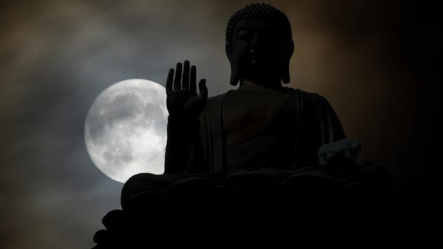Iconic Statue of Buddah at Night in Time Lapse with Full Moon and Clouds