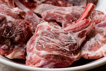 Raw Frozen Bloody Lamb Chops Meat in Plate