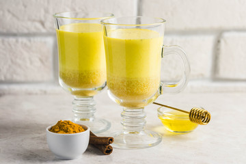 Golden milk with honey and cinnamon. Selective focus, space for text.