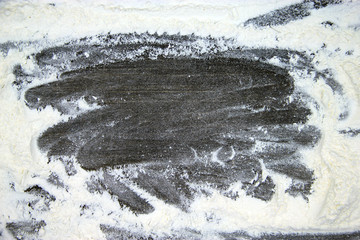 White flour on rustic wooden table, top view. Baking preparation, on wooden board or table