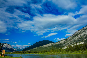 Fototapeta na wymiar Clouds highlight the mountains around Middle Lake, Bow Valley Provincial Park, Alberta, Canada