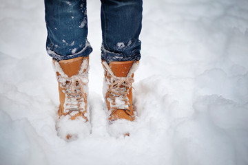 Boots in the snow, woman's boots walking snow weather copy space