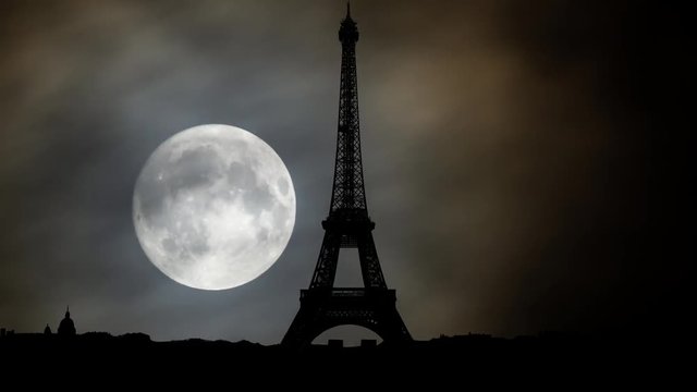 The Eiffel Tower at Night with Full Moon and Clouds in Time Lapse, Paris, France, Europe