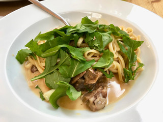 Linguini Pasta with Lamb Meat, Cream Sauce and Arugula, Rocket or Rucola Leaves.