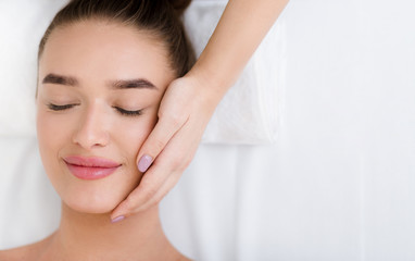 Facial massage. Woman getting professional face treatment