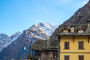 Mountain panorama with peaks, snow, villages, streams and trails