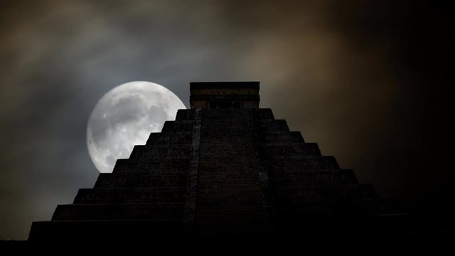 Ancient Mayan pyramid ( Kukulcan Temple ) Time Lapse with Moon and Clouds,  UNESCO world heritage site, Chichen Itza, Yucatan, Mexico.