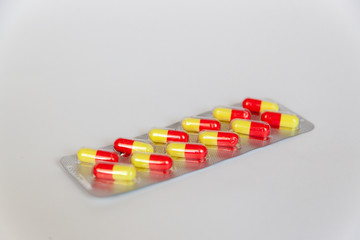 Plate tablets yellow - red in the capsule for the treatment of health and body