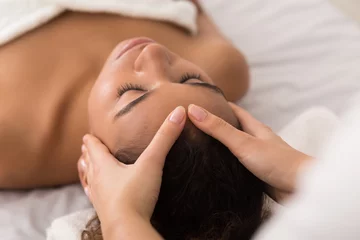 Fotobehang Woman enjoying anti aging facial massage in spa salon © Prostock-studio