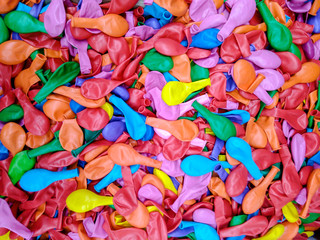 Colored rubber balls to inflate.Inflatable multicolored balls. Background. neon balloons rubber, soft focus