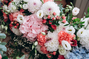 A beautiful bouquet from blue, red, white and pink flowers for decorating festive decor. Natural concept