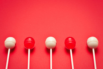 Lollipop on a red background. Space for text or design.