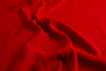 Red silk or satin luxury fabric texture can use as abstract background. Top view