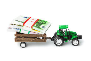 Fototapeta premium Toy tractor with money