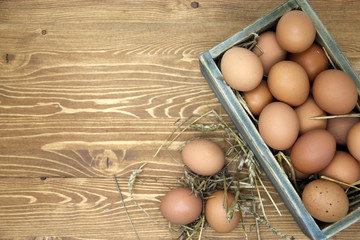 Fresh chicken eggs in wooden box