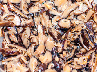 Edible forest mushrooms. Fried Slippery Jack mushrooms Suillus luteus in cast iron pan on old blue...