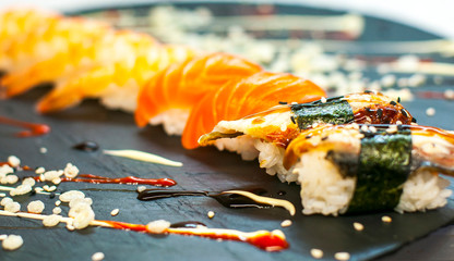 Rainbow Sushi Roll with salmon, eel, tuna, avocado, royal prawn, cream cheese Philadelphia, caviar tobica, chuka. Sushi menu. Japanese food.