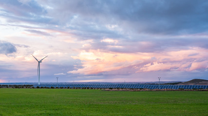 Fototapeta na wymiar Photovoltaic and wind plant at sunset