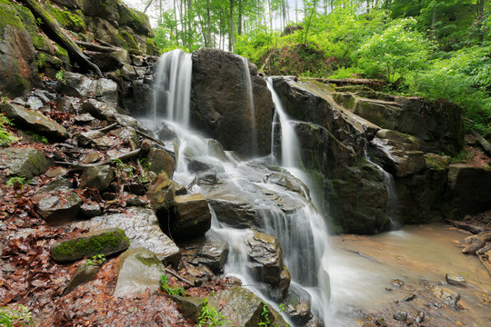 beautiful waterfall among the huge rocks in forest. beautiful nature summer scenery. refreshing environment