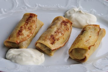 Stuffed Russian pancakes (bliny or blini) served with sour cream in Moscow, Russia