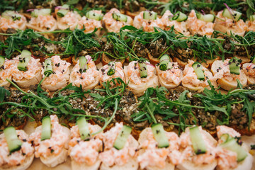 many cupcakes sandwiches fish sauce decorated arugula