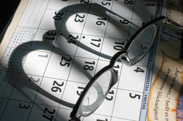 brille liegt auf einem kalender