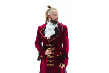 The young man wearing a traditional medieval costume of marquis posing at studio with whip. Fantasy, Antique, Renaissance concept