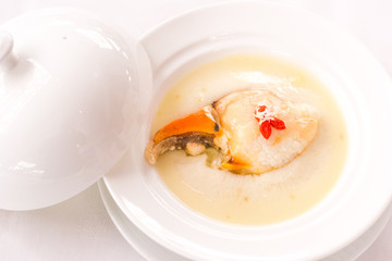 Steamed crab claw with minced ginger and rice wine served in white porcelain