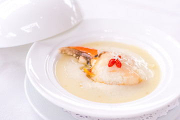 Steamed crab claw with minced ginger and rice wine served in white porcelain