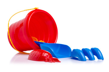 Baby set red sandbox bucket  shovel rake toy on a white background. Isola