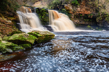 Rocks at Crammel Linn Waterfall, as the River Irthing flows over the 10 metre falls it marks the boundary between Northumberland and Cumbria just north of Gilsland, England