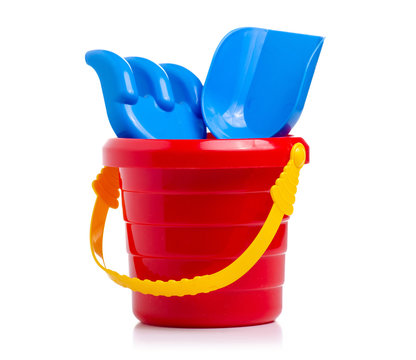 Baby set red sandbox bucket  shovel rake toy on a white background. Isola