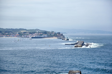 Saint Jean de Luz, France, Basque country, City views Ciboure and Castle and port of Socoa, Sailboats, Ocean waves breaking about the dam