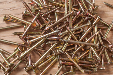 brass nails on a wooden background