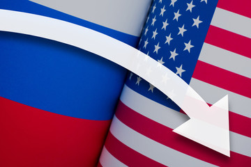 White arrow down on the background of flags of the United States of America and Russia