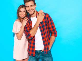 Smiling Beautiful Girl and her Handsome Boyfriend laughing.Happy Cheerful Family.Valentine's Day. Posing near blue wall. Hugging