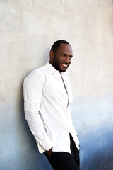 Obraz premium Handsome cheerful african american man in white shirt standing.