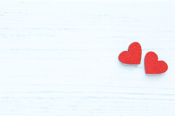 Red hearts on white wooden table