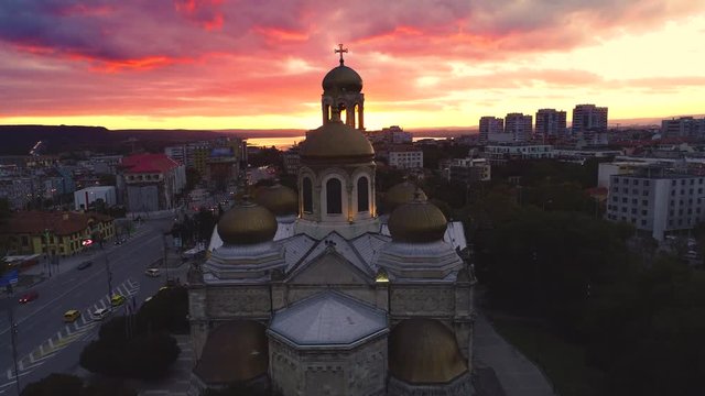 Sunset over the city and sea lake. Aerial view of Varna, Bulgaria and The Cathedral of Assumption.