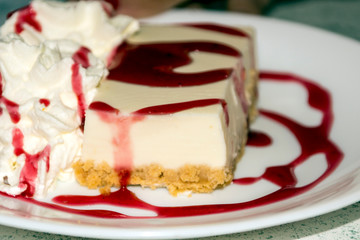 Cheesecake with strawberry syrup served on a plate
