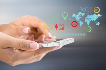 Mobile phone in female hands on a  background