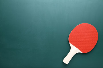 Table tennis racket on green background