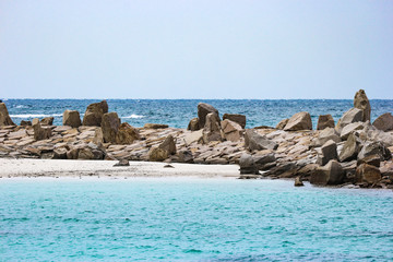 White sand stone beach and blue waves sea at Shirahama beach.