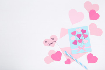 Inscription Be My Valentine with paper hearts and envelope on white background
