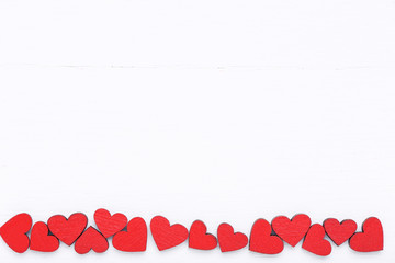 Red valentine hearts on white wooden table