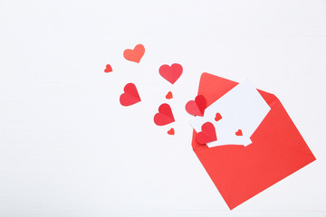 Red paper hearts with envelope on white background