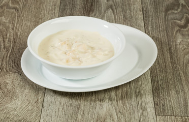 Serving New England Clam Chowder in Rustic Setting