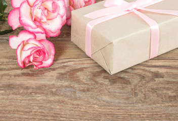 Present or gift box in a craft paper with gold ribbon bow